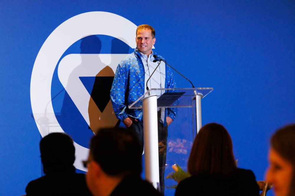 An alum speaker give welcome remarks